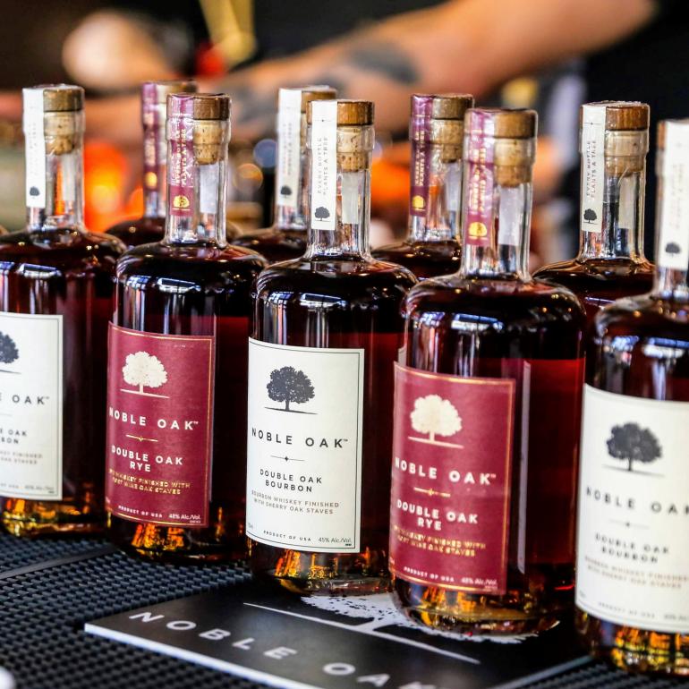 Row of Noble oak bourbon and rye bottles 